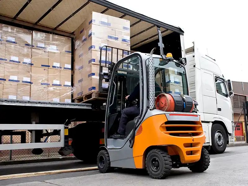 Forklift unloading a truck