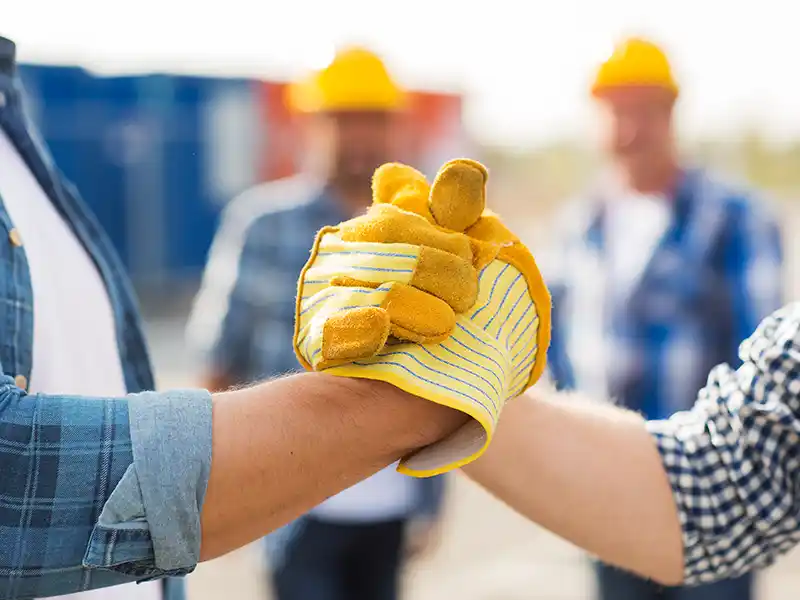 Two contractors shaking hands